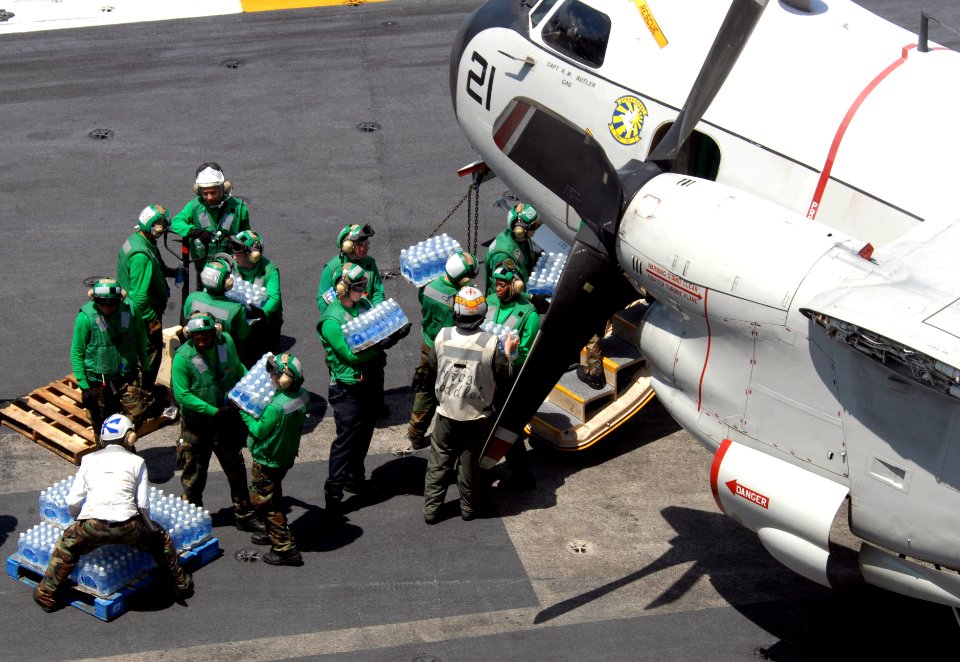 US Navy 080625-N-4005H-002 Sailors load cases of water bound for the Philippines onto a C-2A Greyhound assigned to the