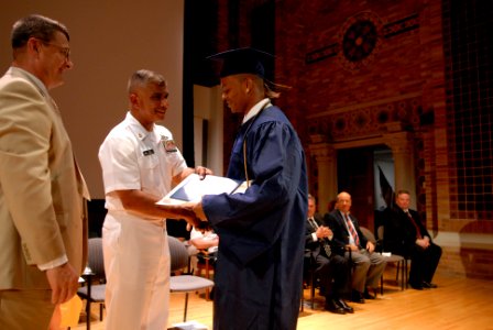 US Navy 080625-N-9818V-206 Master Chief Petty Officer of the Navy (MCPON) Joe R. Campa Jr. presents the graduates of the Western New York Maritime Charter School with their certificates during the first graduation commencement