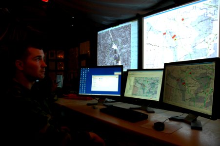 US Navy 080623-N-7367K-004 Steelworker 1st Class Greg Laney, assigned to NMCB-11, monitors the battalion's convoy security elements from the command operations center during a field exercise (FEX) at Camp Shelby