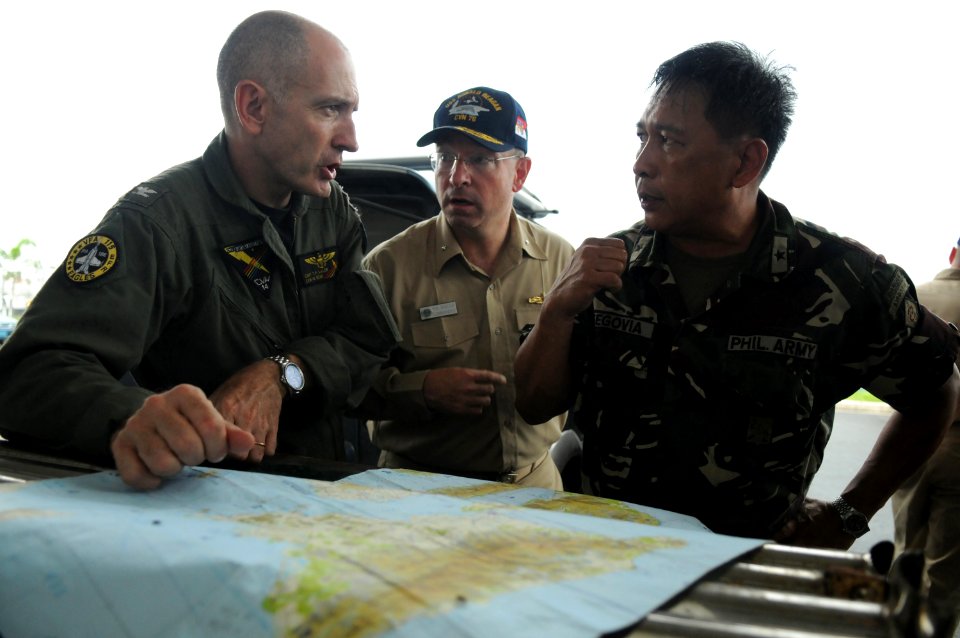 US Navy 080626-N-4009P-040 Rear Adm. James P. Wisecup, Brig. Gen. Jorge Segovia, and Capt. Thomas P. Lalor discuss the current relief efforts