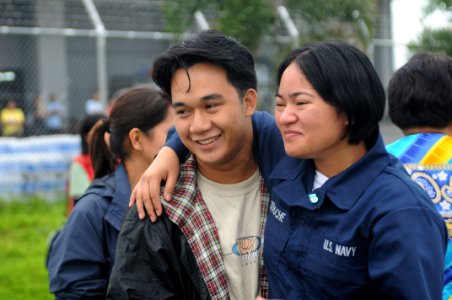 US Navy 080627-N-3659B-059 Storekeeper Seaman Grace Geroche, a native of Iloilo and Sailor assigned to the Nimitz-class aircraft carrier USS Ronald Reagan (CVN 76), embraces her brother upon arriving as part of U.S. Navy relief photo