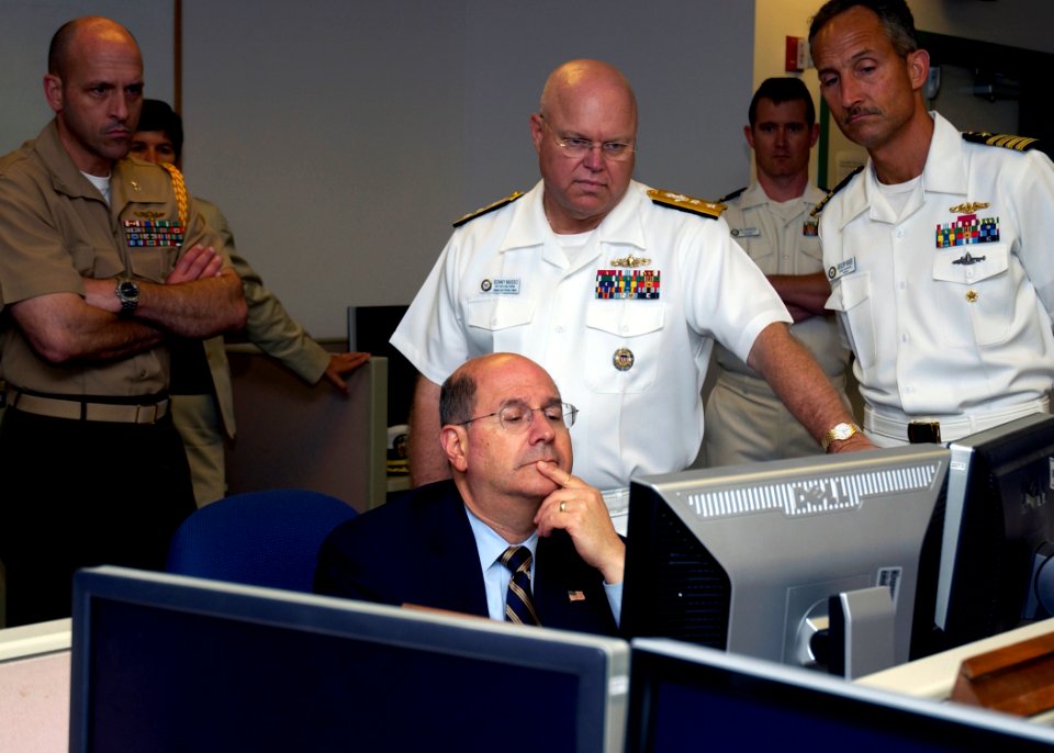 US Navy 080626-N-0659H-013 Secretary of the Navy Donald C. Winter studies a Sailors career information while Rear Adm. Sonny Masso, commander of Navy Personnnel Command (NPC), explains the reviewing process
