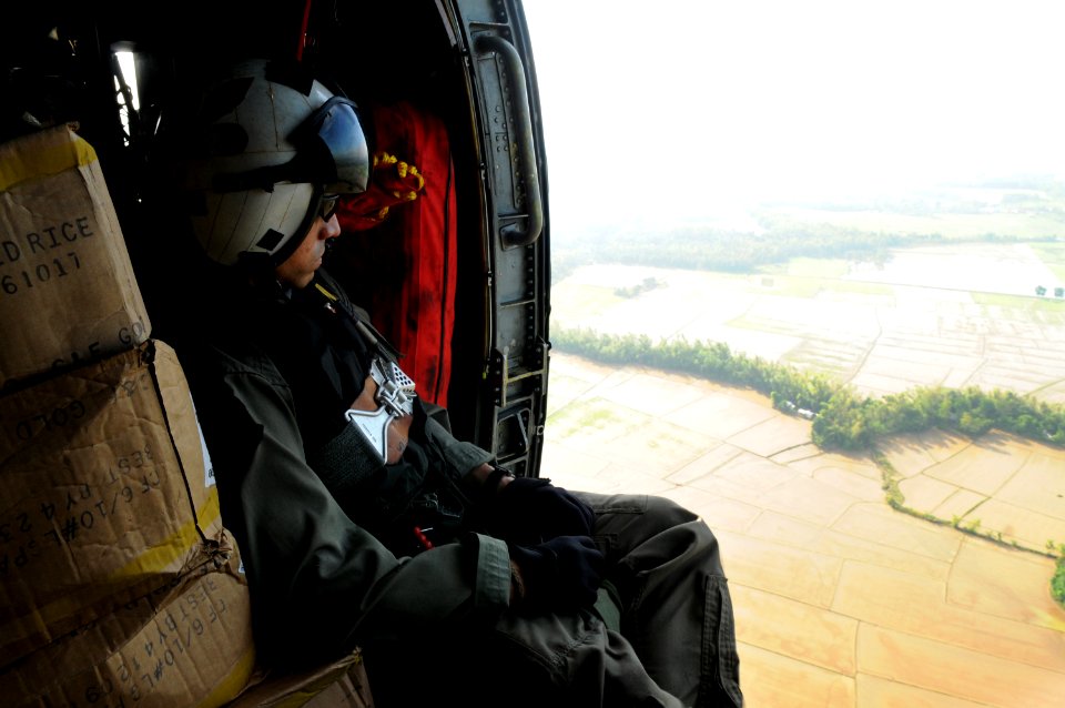US Navy 080626-N-4009P-688 Aviation Warfare Systems Operator 2nd Class Anthony Chavez, of San Bernardino, Calif., looks over flooded areas in the Republic of the Philippines