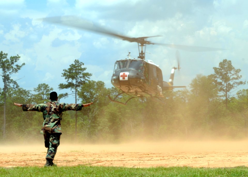 US Navy 080625-N-1120L-081 Chief Boatswain's Mate Cecil Watt, assigned to Naval Mobile Construction Battalion (NMCB) 7, signals a MEDAVAC to land