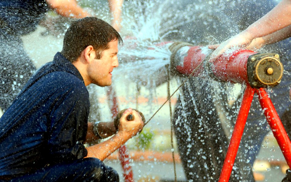 US Navy 080626-N-5345W-043 Aircraft carrier USS Dwight D. Eisenhower (CVN 69) Damage Controlman 3rd Class John Ricker fights the clock and spraying water while trying to apply a marlin wrap to a ruptured pipe in the pipe patchi