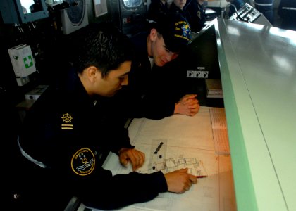 US Navy 080627-N-1226D-154 Chilean sailor Javier Pino Jeria, right, shows U.S. Navy Ens. Shawn Calihan how to plot the ship's location during the Pacific phase of UNITAS 49-08
