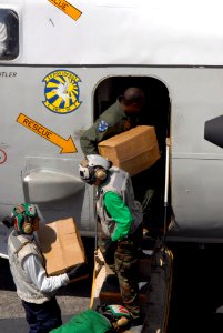 US Navy 080625-N-4005H-028 Sailors load cases of water bound for the Philippines onto a C-2A Greyhound assigned to the