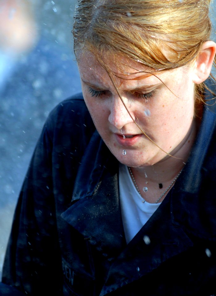 US Navy 080626-N-5345W-054 Damage Controlman Fireman Whitney Yungen endures a non-stop dousing as she and her aircraft carrier USS Dwight D. Eisenhower (CVN 69) teammates compete in the pipe patching event during the Damage Con