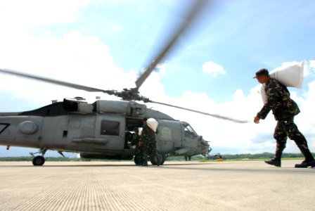 US Navy 080628-N-0640K-031 Members of the Armed Forces of the Philippines (AFP) load an HH-60H Seahawk assigned to the