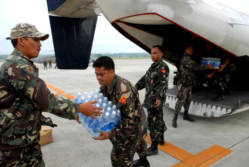 US Navy 080627-N-0640K-190 Service members assigned to the Philippine Army load a C-2A Greyhound with supplies from the Nimitz-class aircraft carrier USS Ronald Reagan (CVN 76) at Iloilo Airport