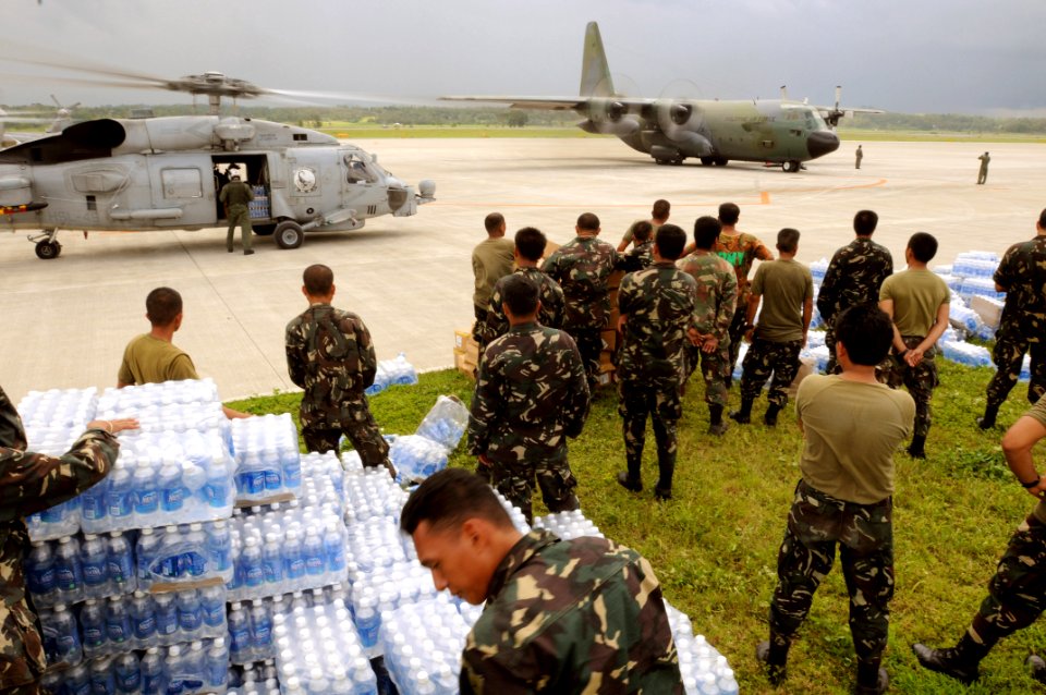 US Navy 080626-N-5961C-011 Servicemen of the Philippine Army stage themselves to transport bottled water to aircrafts assigned to the U.S. Navy and the Republic of the Philippines Air Force