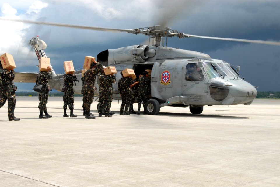 US Navy 080627-N-0640K-578 Service members assigned to the Philippine Army load an SH-60 Seahawk assigned to the