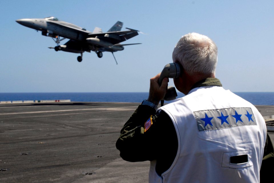 US Navy 080628-N-7883G-093 Adm. Timothy J. Keating, head of the U.S. Pacific Command, acts as a landing signal officer (LSO) as a Strike Fighter Squadron 192 F-A-18C Hornet lands on the flight deck aboard the aircraft carrier U