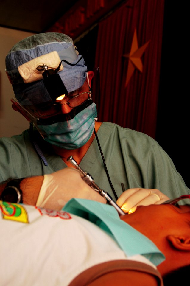 US Navy 080625-N-7498L-259 East Meets West foundation Dental Director Capt. Charles Craft performs a tooth extraction on a Vietnamese child as part of the Pacific Partnership dental civic action program