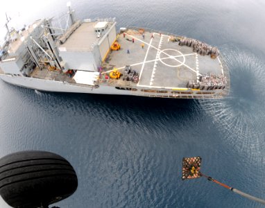 US Navy 080629-N-5961C-009 A HH-60H Seahawk helicopter from Helicopter Anti-Submarine Squadron (HS) 4 lifts another pallet of bottled water from the deck of Military Sealift Command combat stores ship USNS Niagara Falls (T-AFS