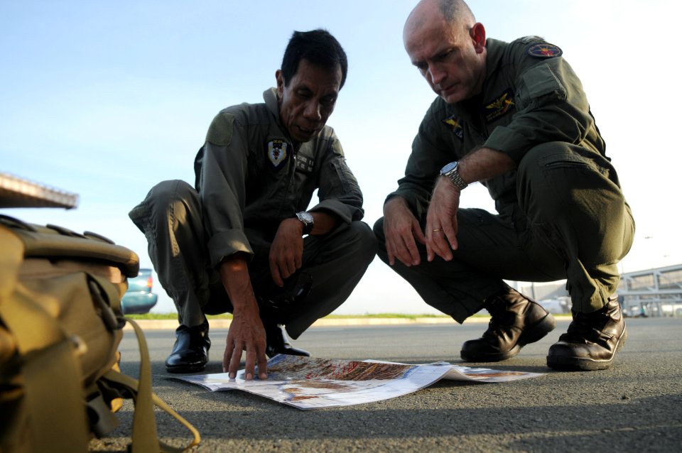 US Navy 080626-N-4009P-556 Lt. Col. Oscar Lasangue, the civil relations commander of Armed Forces of the Philippines (AFP), Central Command, left, and Capt. Thomas P. Lalor, deputy commander of Carrier Air Wing (CVW) 14, discus