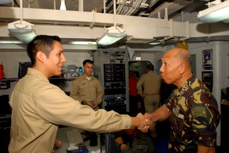 US Navy 080629-N-7730P-009 Armed Forces of the Philippines, Chief of Staff, Gen. Alexander B. Yano shares a handshake with Lt.j.g. Eduardo Vargas. Gen. Yano flew aboard USS Ronald Reagan (CVN 76)