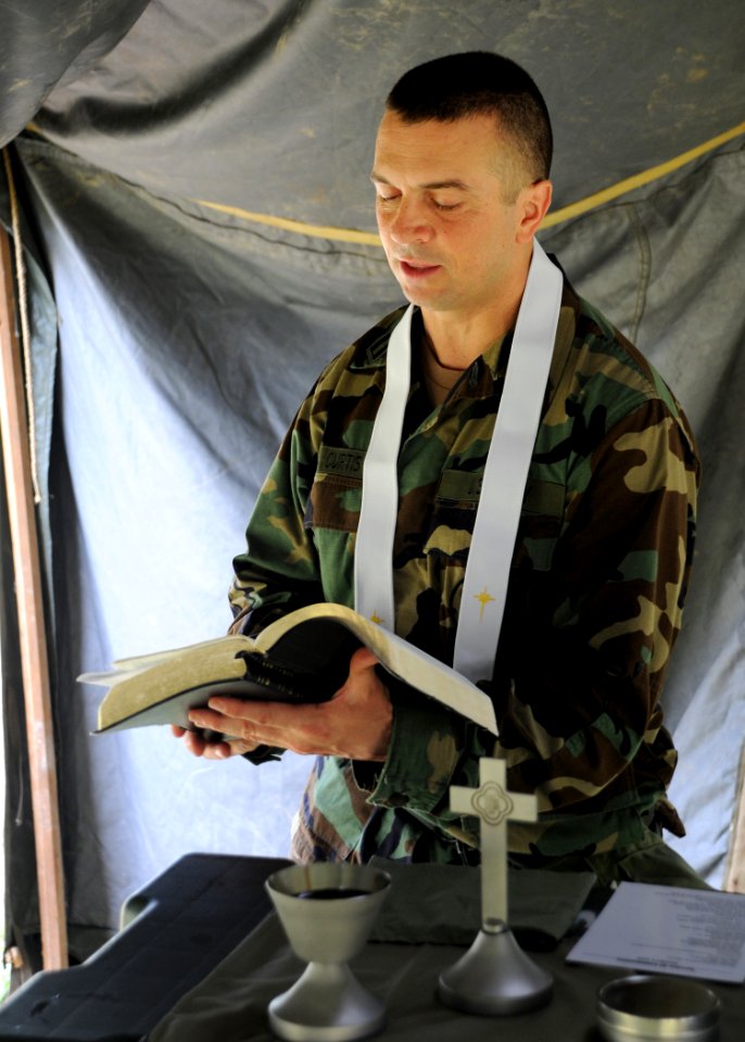US Navy 080629-N-1120L-007 Lt. Daniel Curtis, a chaplain assigned to Naval Mobile Construction Battalion (NMCB) 7, holds a non-denominational service