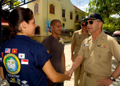 US Navy 080627-N-0209M-005 ice Adm. Doug Crowder, commander, U.S. 7th Fleet, shakes hands with Air Force Senior Airman Arianne J. Sanchez during a tour of the medical civic action program site