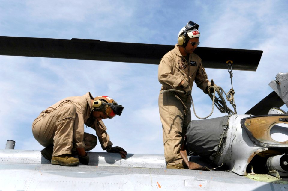 US Navy 080630-F-5735S-010 Sgt. Mark Mace, right, and Sgt. Gustavo Mora, crew chiefs assigned to Marine Medium Helicopter Training Squadron (HMMT) 164, secure the rotor blades of a CH-46E helicopter at Naval Air Station (NAS) L