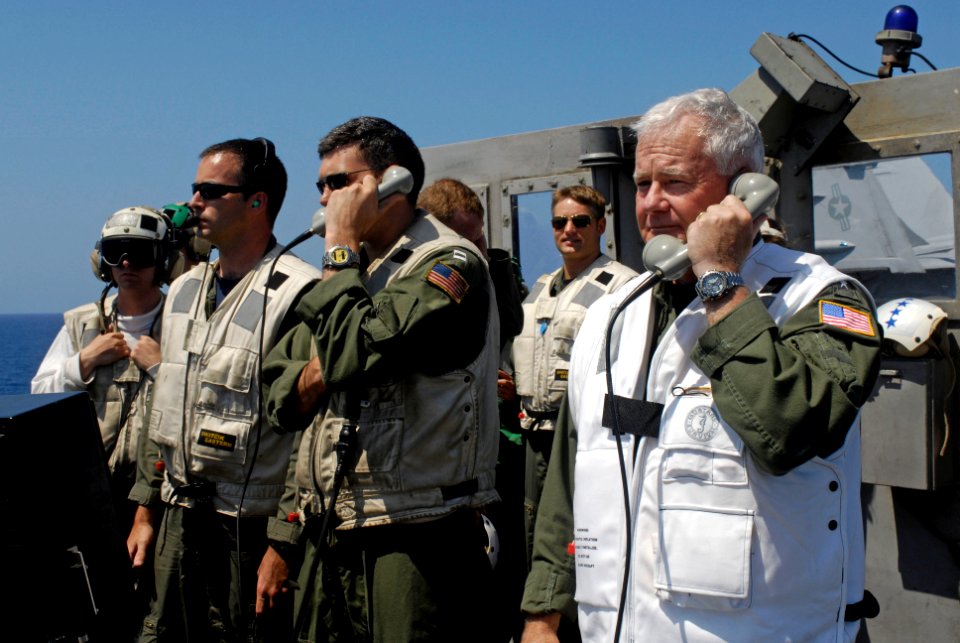 US Navy 080628-N-7883G-064 Adm. Timothy J. Keating, right, head of the U.S. Pacific Command, acts as a landing signal officer (LSO) on the flight deck aboard the aircraft carrier USS Kitty Hawk (CV 63)
