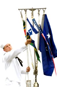 US Navy 080627-N-8467N-003 Electronics Technician 2nd Class Kenneth Walton, assigned to the fast-attack submarine USS Hawaii (SSN 776), hoists the Submarine Squadron 4 pennant