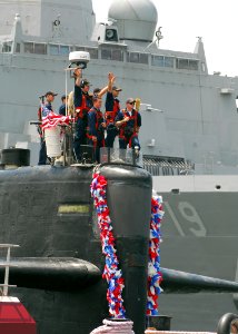 US Navy 080628-N-7705S-056 Troy Jackson, commanding officer, and the crewmembers of the fast-attack submarine USS Norfolk (SSN 714) wave to the families and friends on the pier as they return to Naval Station Norfolk following
