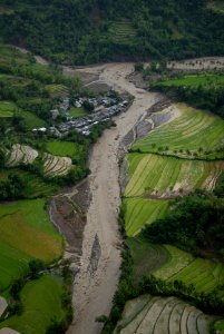 US Navy 080628-N-0640K-259 A flooded river near the city of Alimodian flows dangerously close to buildings
