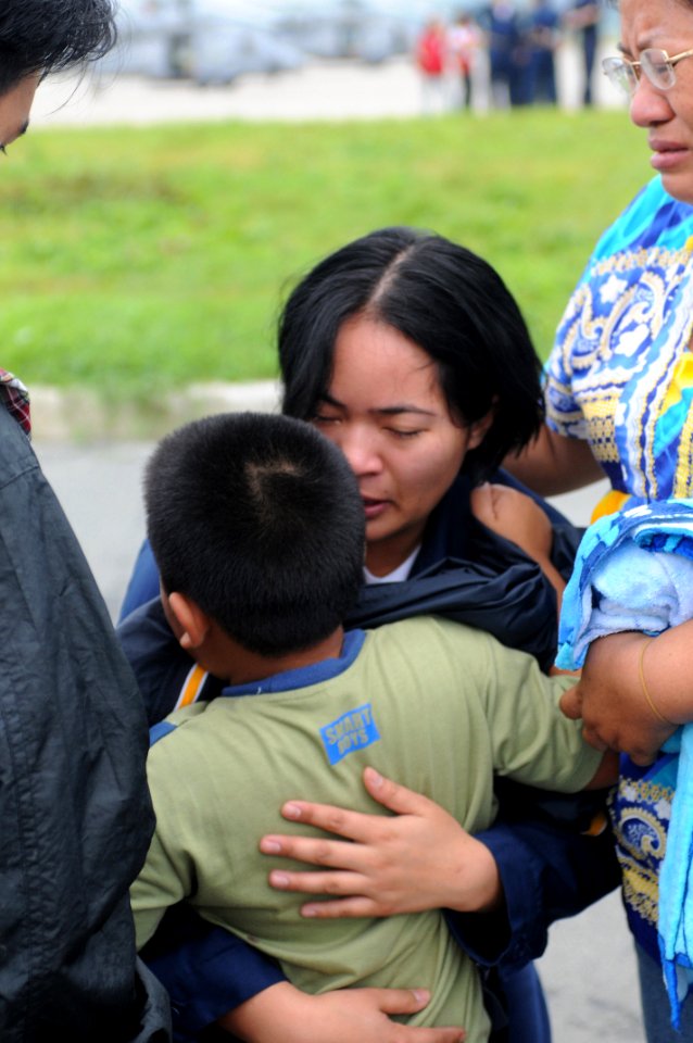 US Navy 080627-N-3659B-048 Storekeeper Seaman Grace Geroche, a native of Iloilo and Sailor assigned to the Nimitz-class aircraft carrier USS Ronald Reagan (CVN 76), embraces her younger brother