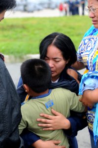 US Navy 080627-N-3659B-048 Storekeeper Seaman Grace Geroche, a native of Iloilo and Sailor assigned to the Nimitz-class aircraft carrier USS Ronald Reagan (CVN 76), embraces her younger brother