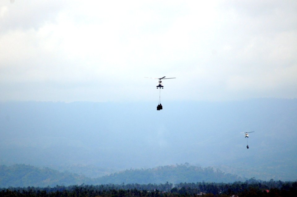 US Navy 080629-N-5961C-007 Super PUMA helicopters fly much needed bottled water to Kalibo, Republic of the Philippines from the deck of the Military Sealift Command combat stores ship USNS Niagara Falls (T-AFS 3)