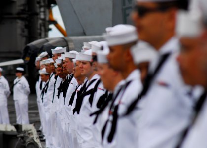 US Navy 080701-N-2638R-005 Sailors man the rails on USS Kitty Hawk's (CV 63) flight deck as the ship pulls into Pearl Harbor for Rim of the Pacific (RIMPAC) 2008