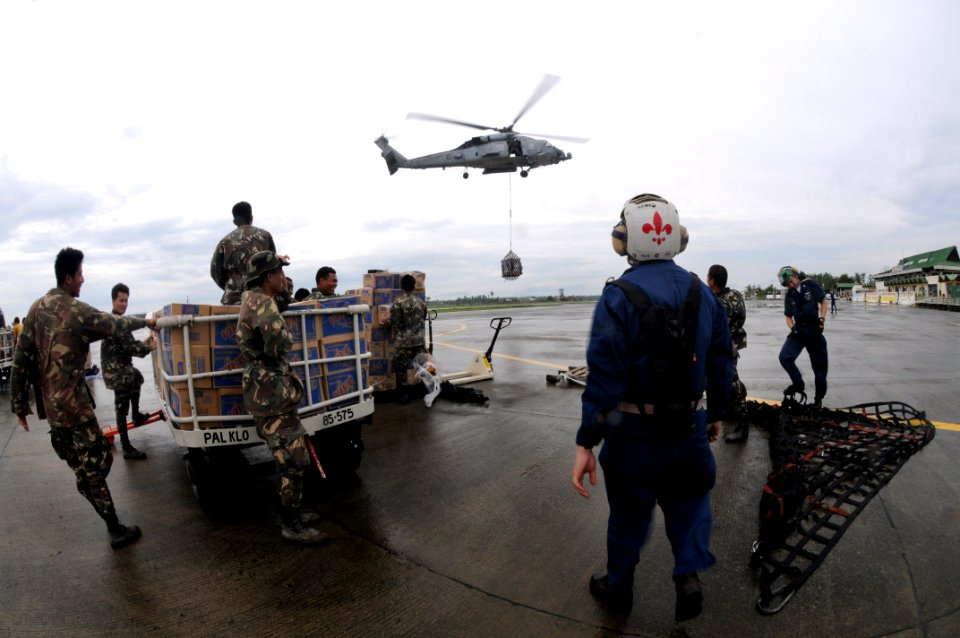 US Navy 080629-N-5961C-011 A HH-60H helicopter from Helicopter Anti-Submarine Squadron (HS) 4 delivers another pallet of bottled water from the deck of USNS Niagara Falls (T-AFS 3)