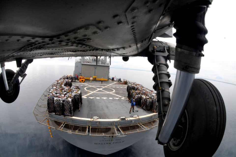 US Navy 080629-N-5961C-016 A HH-60H Seahawk helicopter from Helicopter Anti-Submarine Squadron (HS) 4 lifts another pallet of bottled water from the deck of Military Sealift Command combat stores ship USNS Niagara Falls (T-AFS