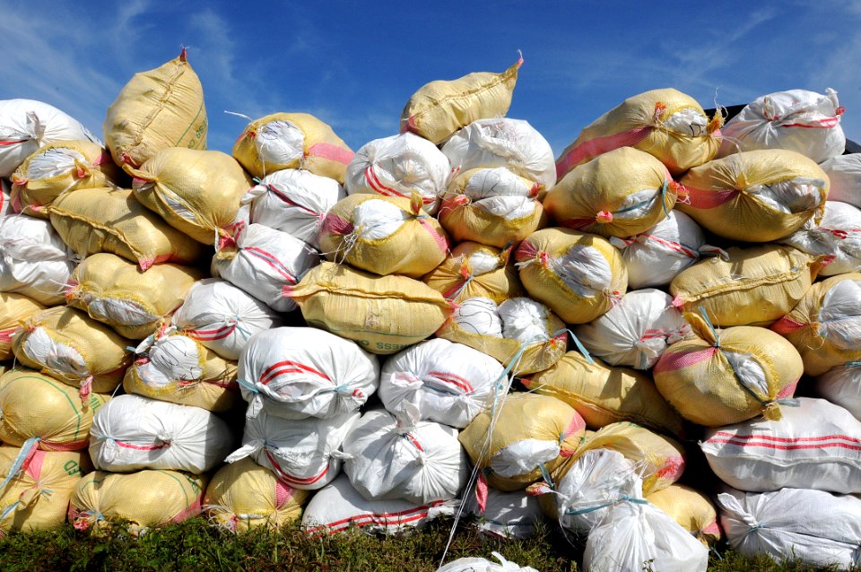 US Navy 080630-N-5961C-008 100-pound sacks of rice are stacked before being loaded into U.S. Navy helicopters assigned to the Ronald Reagan Carrier Strike Group