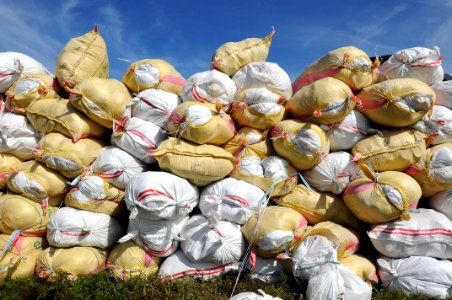US Navy 080630-N-5961C-008 100-pound sacks of rice are stacked before being loaded into U.S. Navy helicopters assigned to the Ronald Reagan Carrier Strike Group