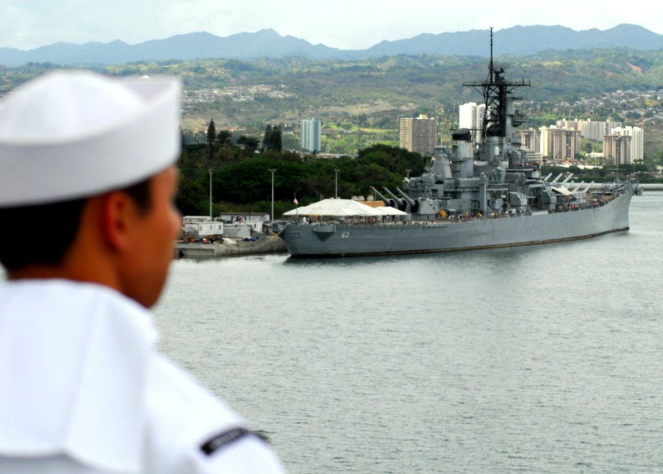 US Navy 080701-N-2638R-002 Aviation Support Equipment Technician 3rd Class Darwin Payawal, of San Diego, Calif., looks at the battleship USS Missouri (BB 63) while manning the rails aboard the aircraft carrier USS Kitty Hawk (C
