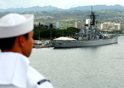 US Navy 080701-N-2638R-002 Aviation Support Equipment Technician 3rd Class Darwin Payawal, of San Diego, Calif., looks at the battleship USS Missouri (BB 63) while manning the rails aboard the aircraft carrier USS Kitty Hawk (C