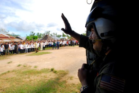 US Navy 080701-N-0640K-191 Aviation Warfare Systems Operator 2nd Class Jeremy Thomas, a native of Warren, Ohio, waves to citizens of the Municipality of Balasan, Philippines after delivering hygiene items, water and tents to th