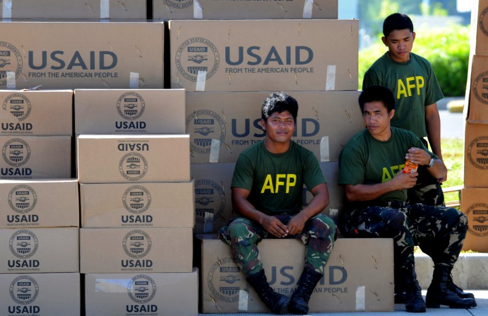 US Navy 080701-N-5961C-008 Servicemen from the Armed Forces of the Philippines rest after moving humanitarian supplies delivered by helicopters from the Ronald Reagan Carrier Strike Group