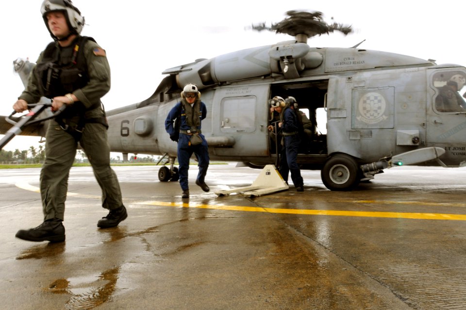 US Navy 080629-N-5961C-002 Sailors from the Ronald Reagan Carrier Group debark an HH-60H Seahawk assigned to Helicopter Anti-Submarine Squadron (HS) 4 while delivering bottled water