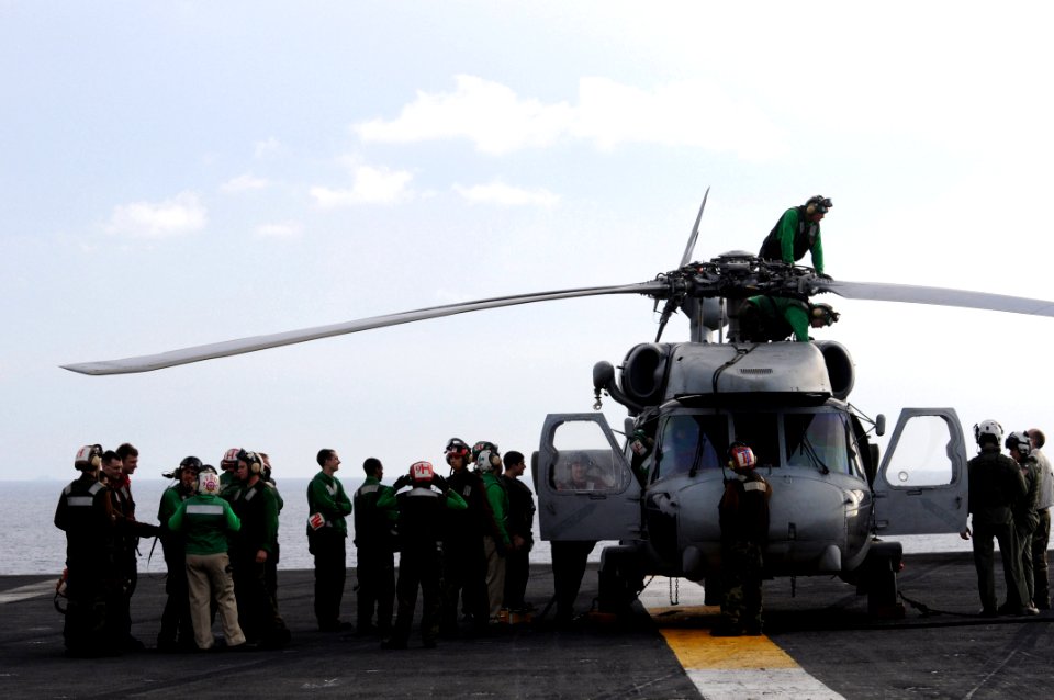 US Navy 080630-N-3659B-086 Flight deck personnel stand by as last minute maintenance is performed on an SH-60F Seahawk