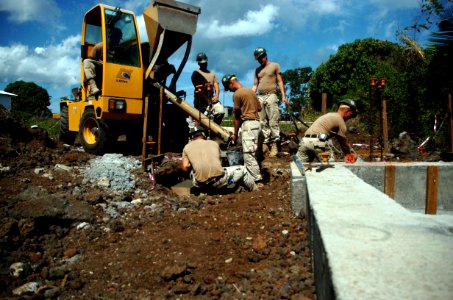 US Navy 080707-N-3674H-331 Seabees assigned to Naval Mobile Construction Battalion (NMCB) 74 pour a concrete foundation at the Hamramba Primary School in Moroni