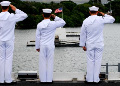 US Navy 080701-N-2638R-004 Sailors salute the USS Arizona Memorial from flight deck of the aircraft carrier USS Kitty Hawk (CV 63) as the ship pulls into Pearl Harbor for Rim of the Pacific (RIMPAC) 2008
