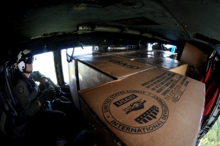 US Navy 080701-N-5961C-014 viation Warfare Systems Operator Slavek Glownia sits among relief supplies in the aft section of an SH-60F Seahawk helicopter assigned to Helicopter Anti-Submarine Squadron (HS) 4