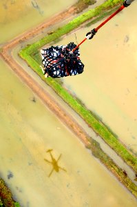 US Navy 080629-N-5961C-010 A HH-60H Seahawk helicopter from Helicopter Anti-Submarine Squadron (HS) 4 transports another pallet of bottled water from the deck of Military Sealift Command combat stores ship USNS Niagara Falls (T