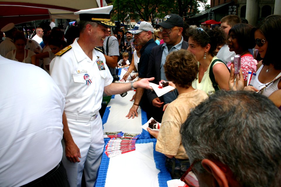 US Navy 080701-N-8110K-091 Rear Adm. Kenneth Braithwaite, vice chief of Information, serves cake to the crowd gathered at historic Faneuil Hall in Boston