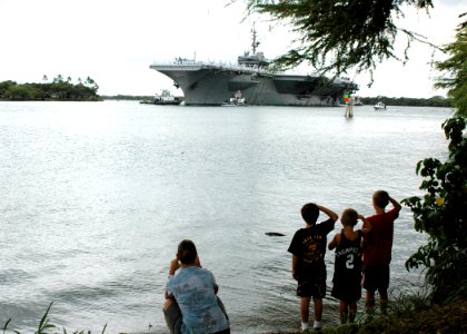 US Navy 080701-N-9076B-002 Children salute the aircraft carrier USS Kitty Hawk as the ship enters Naval Station Pearl Harbor. Kitty Hawk is making a port visit to Pearl Harbor before taking part in exercise Rim of the Pacific 2