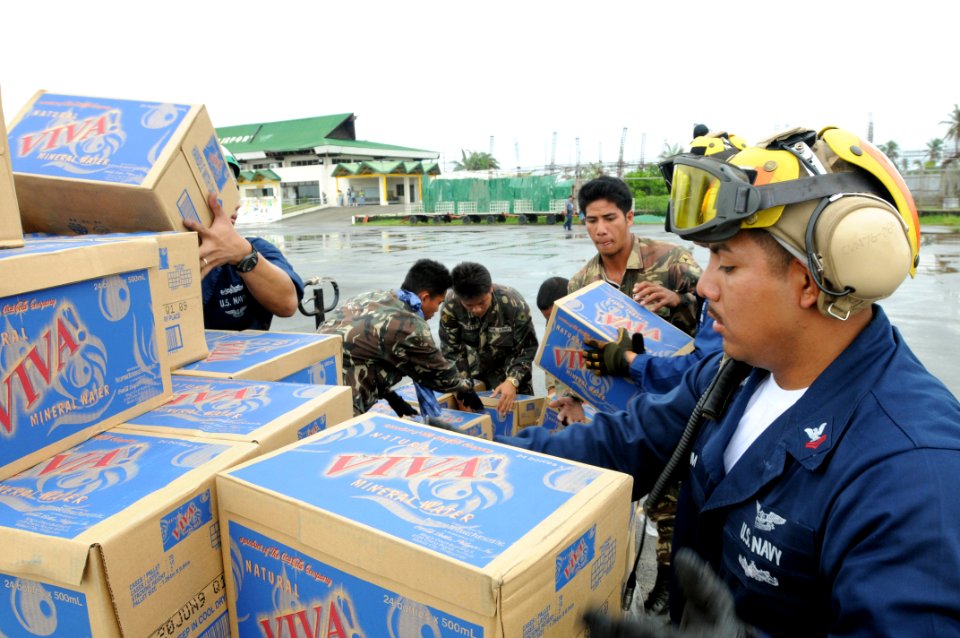 US Navy 080629-N-5961C-014 Aviation Boatswains Mate (Handler) 2nd Class William Sum unloads bottled water during relief efforts in wake of Typhoon Fengshen
