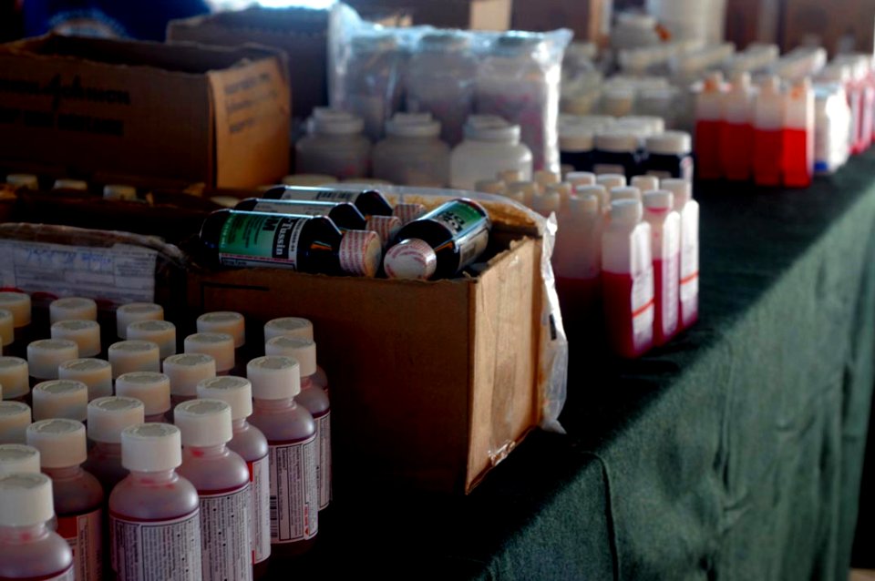 US Navy 080710-G-9679C-926 Medicines and first aid treatment supplies line the table of a temporary pharmacy set-up at the Kebangsaan School